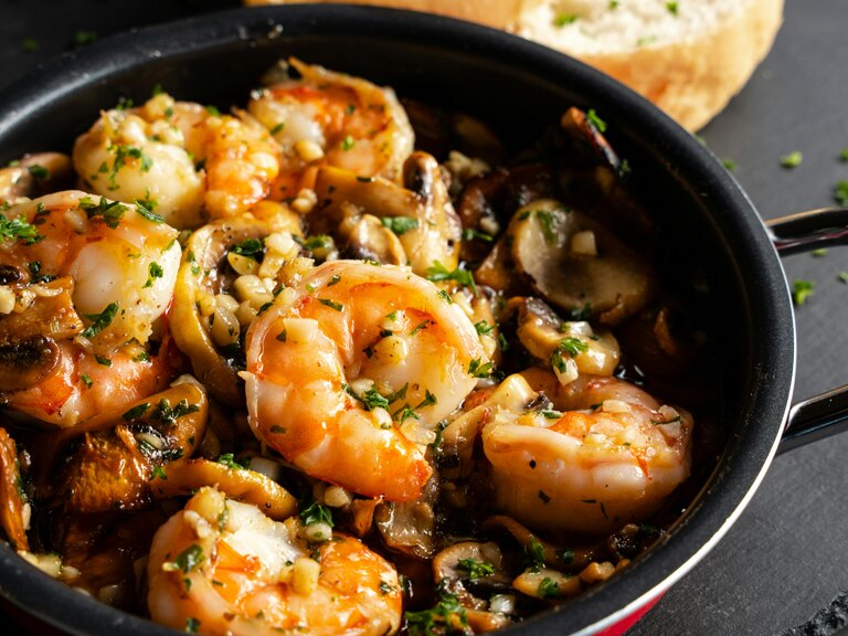 people cooking tapas workshop: gambas al ajillo